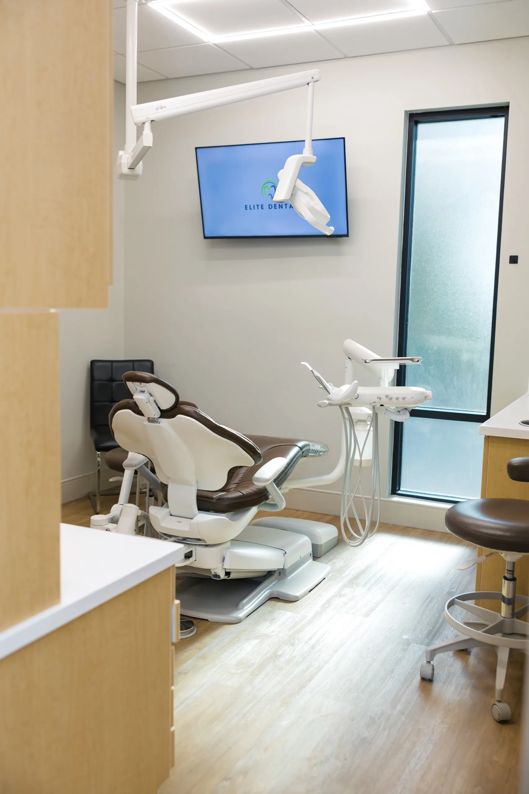 A bright treatment room with an Elite Dental display at the Kirk Road office.